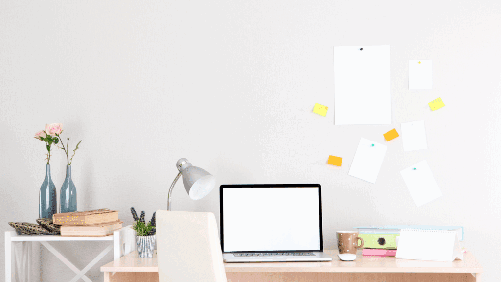 Minimalist workspace with candle, planner, and plant, aligning environment for meaningful life”