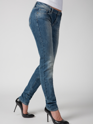 Woman modeling mid rise straight jeans with heels