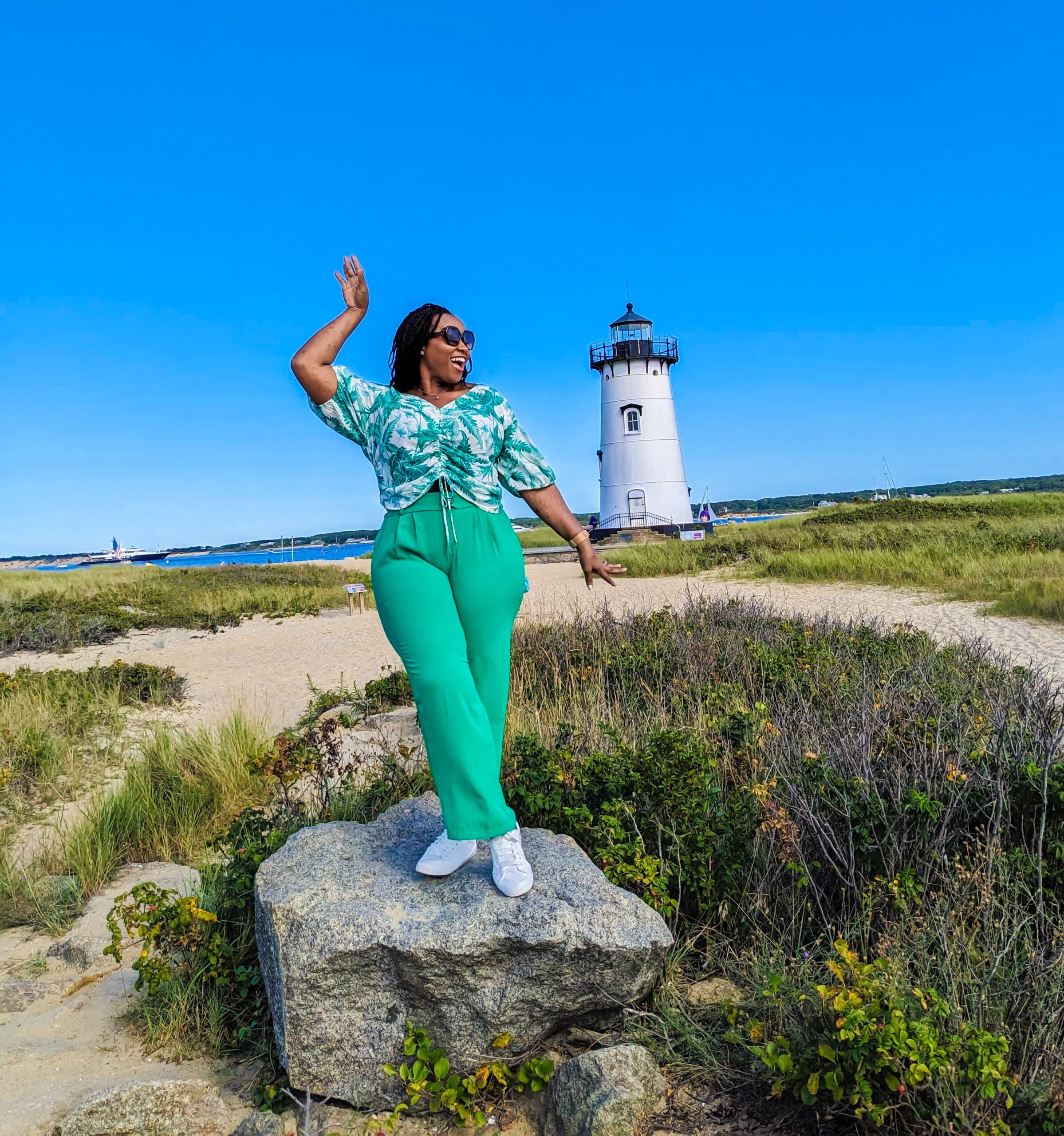 Woman standing on a rock, feeling happy and successful
