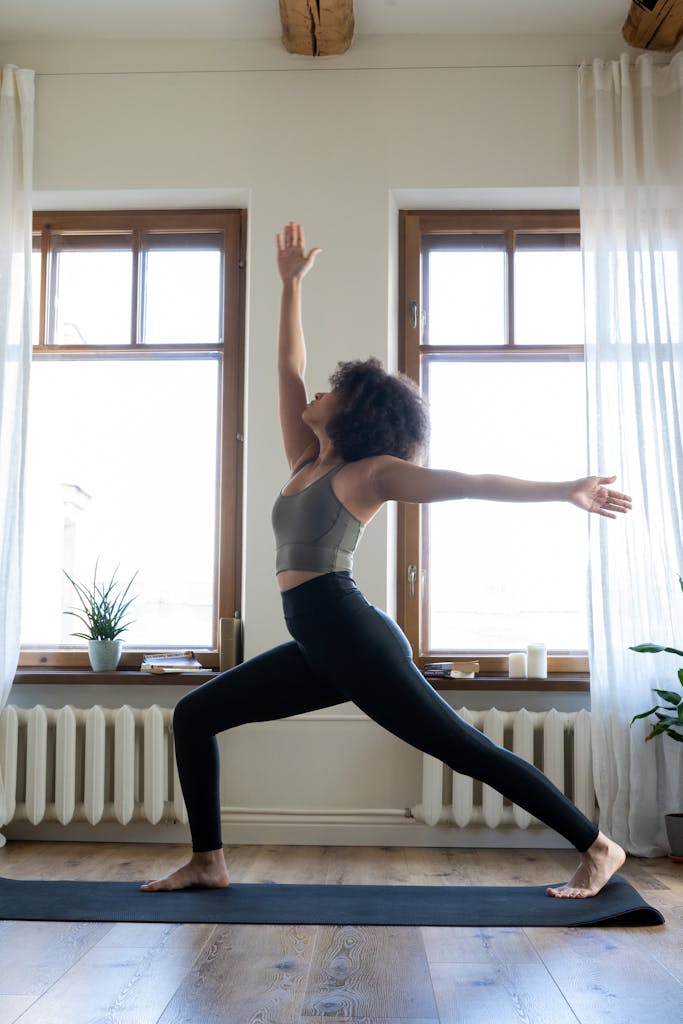 Woman practicing yoga in a well-lit modern home Gentle Movement: A Healing Slow Living Ritual for Women Over 35