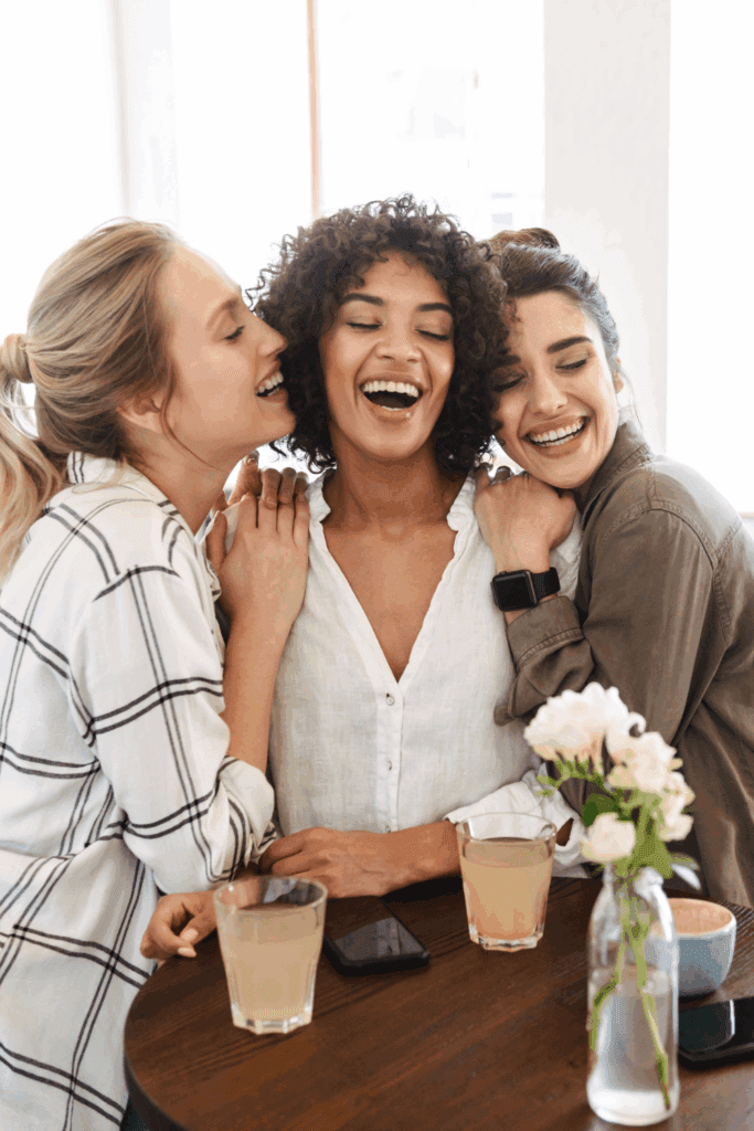 A group of women having tea and laughing, fostering meaningful connections