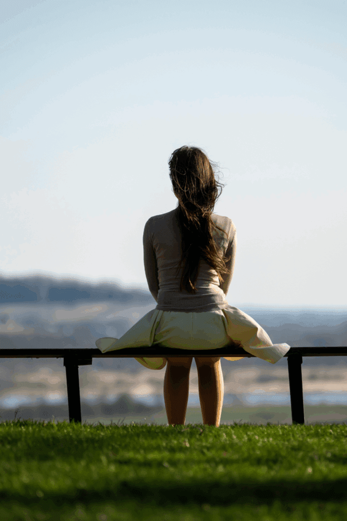 Woman sitting alone – symbolizes decision-making and inner searching.