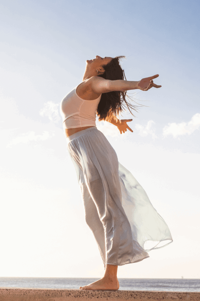 woman with arms stretched embracing the Reinvention mindset