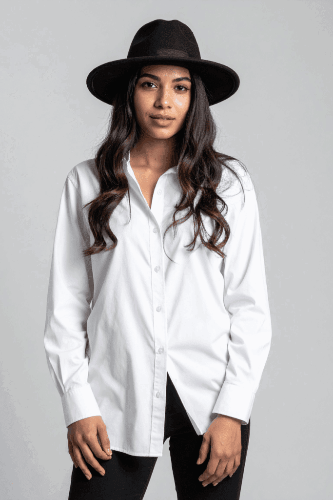 woman styled in Button-Down Shirt and hat for a classy look