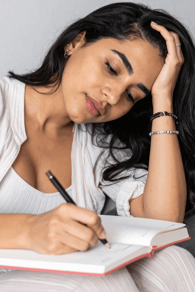 Woman over 35 writing journal for healing, self-love & resilience