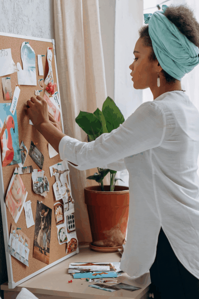 Woman Working on a vision board or dream map – represents reinvention to stop feeling behind in life.