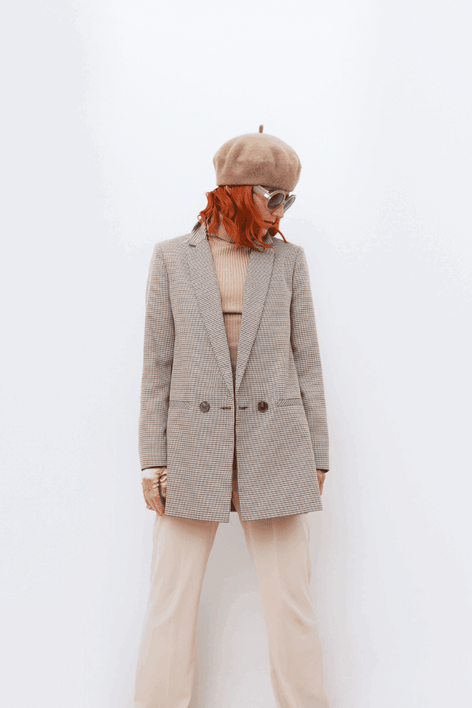 woman modeling a structured houndstooth blazer