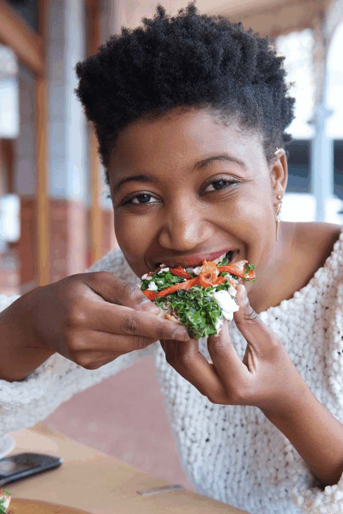 Woman eating greens to Boost Energy Naturally 