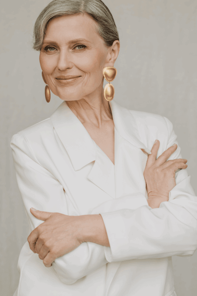 Woman smiling in statement earrings, Belt accessories that brings joy