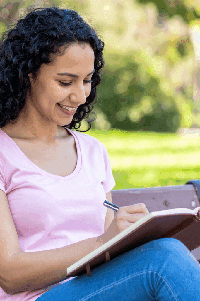 Woman journing in at the park for self-discovery
