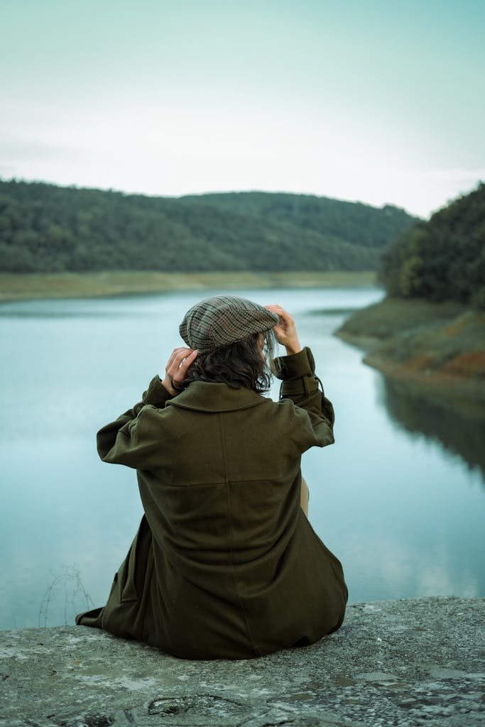 Woman sitting at lake looking thinking of starting over after 35