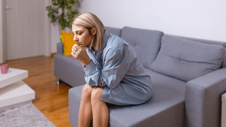 Woman sitting on Sofa at night, nighttime overthinking